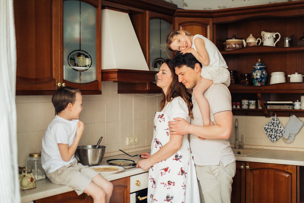 family in kitchen, cover photo of article
