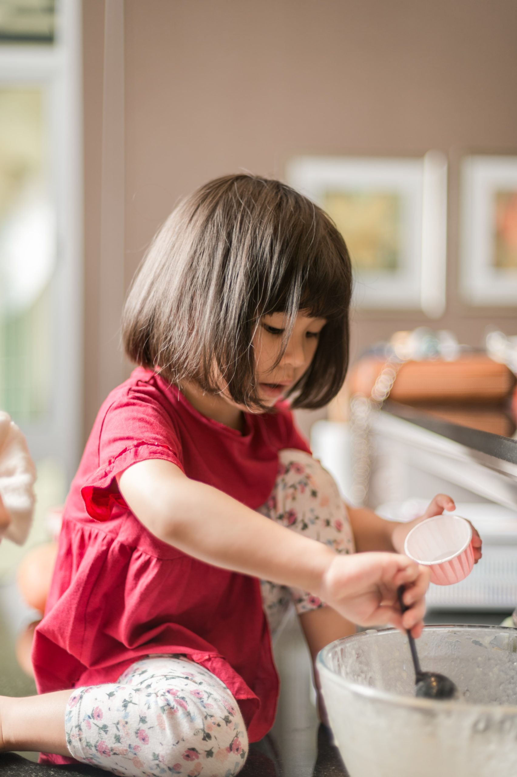 Cover image for blog post showing a child making cupcakes with her family